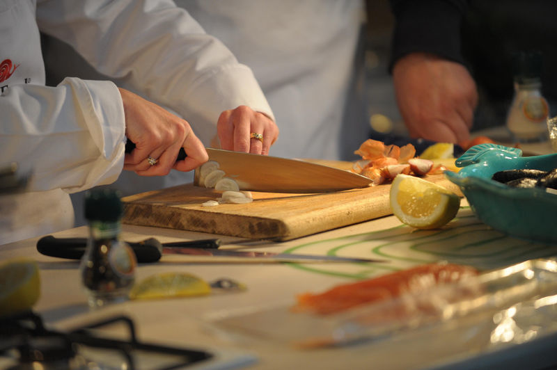 student chopping garlic