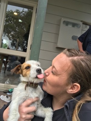 New Zealand Study Abroad student posses with a small dog