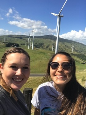 New Zealand study abroad students pose in front of windmills