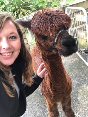 New Zealand student poses with a lama