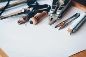Picture of various tools laid out on a sheet of paper