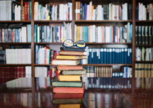 stack of books with glasses on top