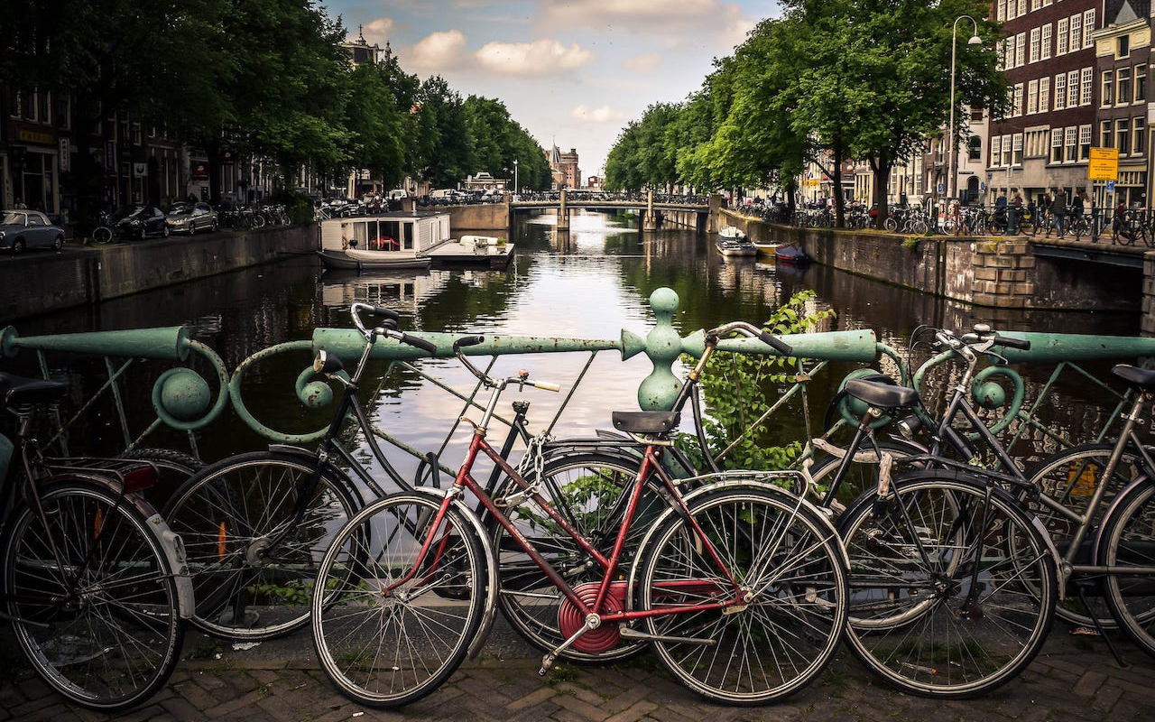 Canal in Holland with bikes chained to a rail