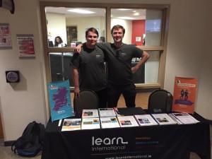 two learn international reps stand at a table with leaflets
