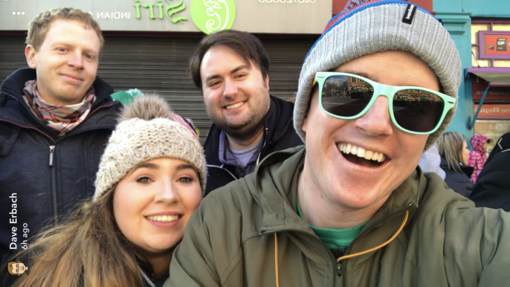 Ireland Intern smiles with three friends waiting for the parade