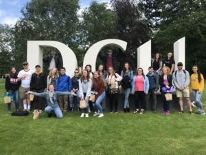 International summer school students pose together in front of the DCU sign