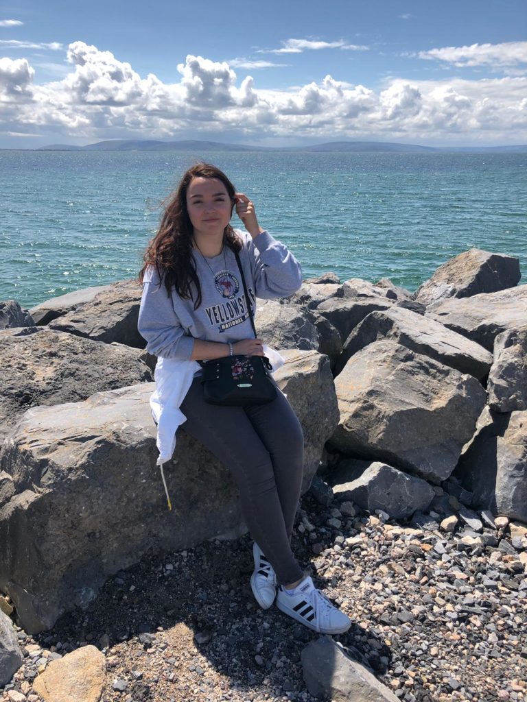 Student poses in front of Galway Bay