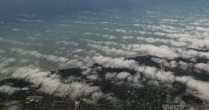 Picture of the sky and ground from an airplane