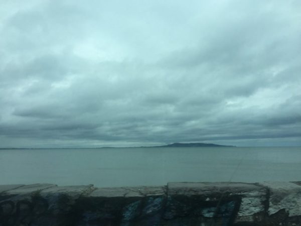 A view of a cloudy sea from out of the DART train window