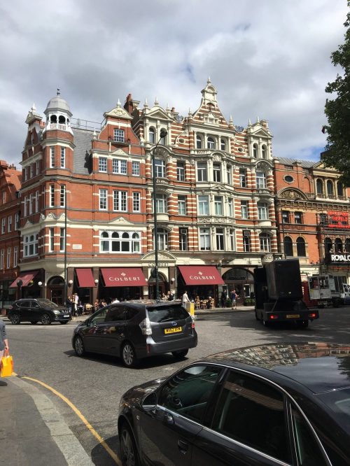 Picture of an ornate building and traffic in London